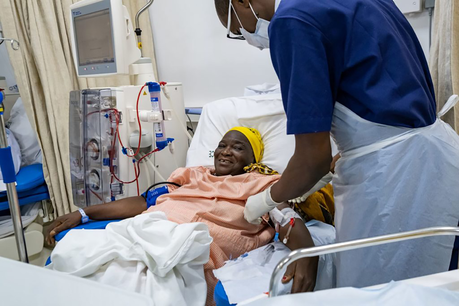 hpw-tanzania-diabetic-patient A patient on a hospital bed receiving dialysis treatment from a health care worker