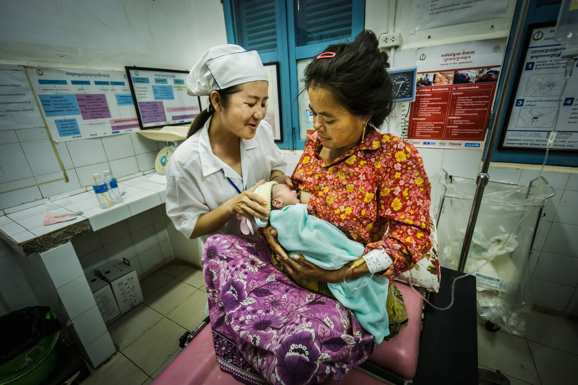 A nurse is assisting a mother breastfeeding in a referral provincial hospital in Cambodia
